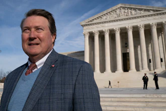 Mitch Hungerpiller of Birmingham, Alabama, who invented a computerized system to automate the processing of returned mail, poses for a photo outside of the Supreme Court in Washington.