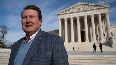 Mitch Hungerpiller of Birmingham, Alabama, who invented a computerized system to automate the processing of returned mail, poses for a photo outside of the Supreme Court in Washington.