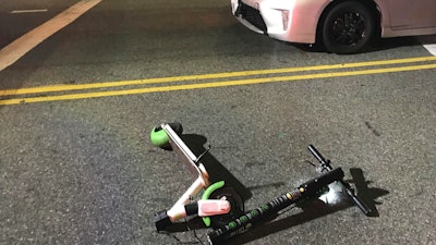 In this Dec. 23, 2018, a scooter Andrew Hardy was riding sits near the car that hit him while riding the scooter in Los Angeles.