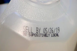 This Friday, May 24, 2019 photo shows the 'sell by' date for a jug of milk in New York. In May 2019, U.S. regulators are again urging food makers to reduce the variety of terms like 'best by' and 'use by' that cause confusion about when food should be thrown out.