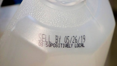 This Friday, May 24, 2019 photo shows the 'sell by' date for a jug of milk in New York. In May 2019, U.S. regulators are again urging food makers to reduce the variety of terms like 'best by' and 'use by' that cause confusion about when food should be thrown out.