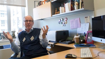 In this Tuesday, April 16, 2019, photo Steve Burghardt, a professor of social work at the City University of New York, gestures as he speaks in his office at Hunter College's Silberman School of Social Work. Seniors in major metropolitan areas, especially in big Northeastern cities and around Washington, D.C., are more likely to continue working past 65 than those in other areas around the country, according to an analysis of Census data by The Associated Press and the NORC Center for Public Affairs Research.