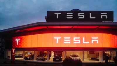 Street View Of Tesla Motors Showroom With Cars Inside And Illuminated Logo Brandin At Dusk London Uk 803666444 2125x1417 (1)