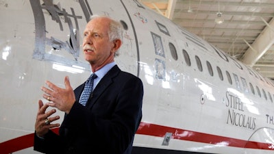 In this June 11, 2011, file photo, former Capt. Chesley 'Sully' Sullenberger talks to the media in front of the US Airways flight 1549 aircraft at the Carolina Aviation Museum in Charlotte, N.C. The president of the pilots' union at American Airlines says Boeing made mistakes in its design of the 737 Max and not telling pilots about new flight-control software on the plane. Sullenberger, the captain who safely landed a disabled jetliner on the Hudson River in 2009, is also expected to testify. He has said that Boeing was more focused on protecting its product, the Max, than protecting the people who use it.