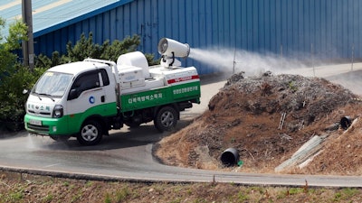 In this June 3, 2019, photo, Health officials spray disinfectant solution as a precaution against African swine fever near a pig farm in Incheon, South Korea. South Korea is concerned North Korea is ignoring its calls for joint efforts to stem the spread of highly contagious African swine fever following an outbreak in North Korea.