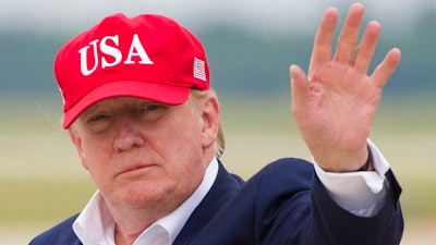 President Donald Trump waves as he steps off Air Force One after arriving, Friday, June 7, 2019, at Andrews Air Force Base, Md.