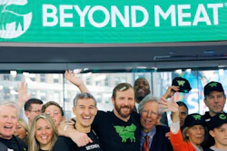 In this May 2, 2019, file photo Ethan Brown, center, CEO of Beyond Meat, attends the Opening Bell ceremony with guests to celebrate the company's IPO at Nasdaq in New York. Plant-based meat maker Beyond Meat beat Wall Street’s expectations in its first earnings report since its IPO last month. The El Segundo, California-based company lost $6.6 million, or 95 cents per share, in the first quarter, up slightly from a 98-cent loss in the same period a year ago.