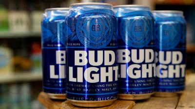 In a Thursday Jan. 10, 2019 file photo, cans of Bud Light beer are seen in Washington. Anheuser-Busch says a new solar facility in Texas will help it meet its goal of brewing all its U.S. beers using renewable energy. The country’s largest brewer is partnering with San Francisco-based solar developer Recurrent Energy, which will build and maintain the 2,000-acre solar farm in Pecos County. When the solar farm is completed in 2021, Anheuser-Busch will buy credits to offset the electricity it uses at its 22 U.S. breweries.