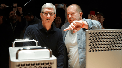 FILE - In this Monday, June 3, 2019 file photo, Apple CEO Tim Cook, left, and chief design officer Jonathan Ive look at the Mac Pro in the display room at the Apple Worldwide Developers Conference in San Jose, Calif. On Thursday, June 27, 2019, Apple said that Ive, chief design officer, will be leaving after more than two decades at the company to start his own firm.