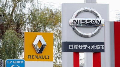 This Nov. 20, 2018, photo shows the logos of Nissan Motor Co. and Renault at car dealerships in Kawaguchi, north of Tokyo. Japanese automaker Nissan wasn’t consulted about a proposed merger between its French alliance partner Renault and Fiat Chrysler and has little say over the issue. Partnering with a colossal Renault-Fiat Chrysler could help Nissan slash costs on shared components and research.