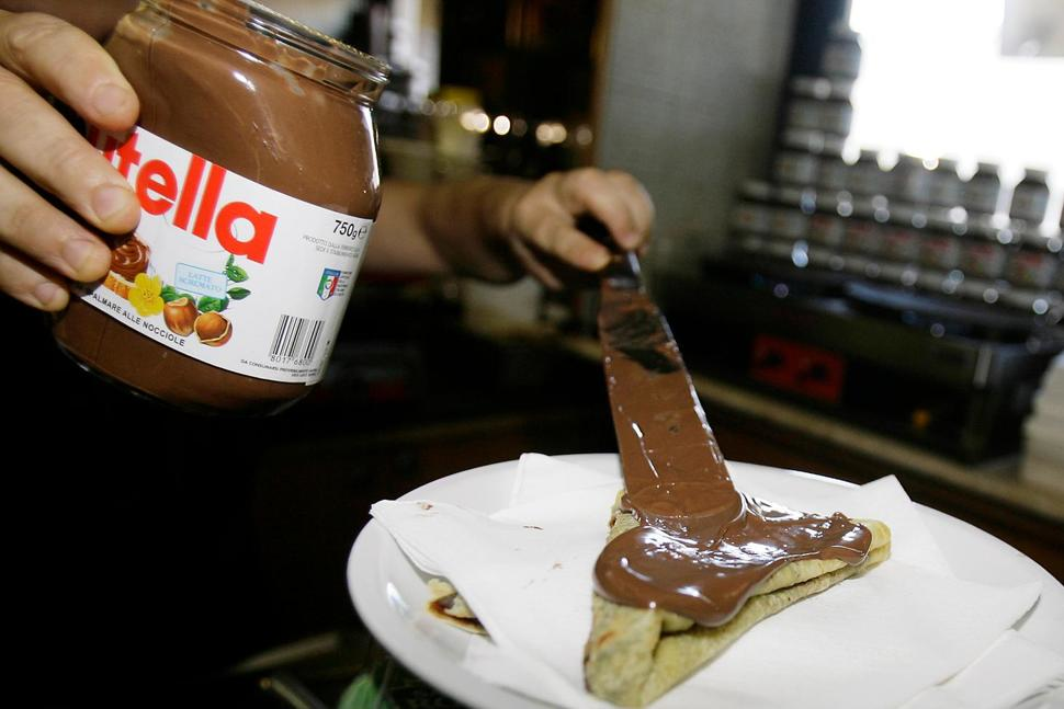 In this June 18 2010 file photo,a bartender spreads Nutella on a crepe in a creperie in Rome. French workers frustrated over salary negotiations are blocking the world's biggest Nutella factory. Tensions are mounting at the site in Villers-Ecalles in Normandy, where activists from the Workers' Force union have been blocking trucks from entering or leaving the factory for a week.