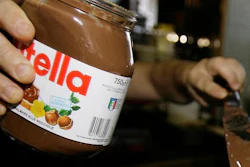 In this June 18 2010 file photo,a bartender spreads Nutella on a crepe in a creperie in Rome. French workers frustrated over salary negotiations are blocking the world's biggest Nutella factory. Tensions are mounting at the site in Villers-Ecalles in Normandy, where activists from the Workers' Force union have been blocking trucks from entering or leaving the factory for a week.