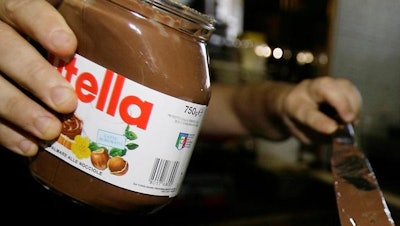 In this June 18 2010 file photo,a bartender spreads Nutella on a crepe in a creperie in Rome. French workers frustrated over salary negotiations are blocking the world's biggest Nutella factory. Tensions are mounting at the site in Villers-Ecalles in Normandy, where activists from the Workers' Force union have been blocking trucks from entering or leaving the factory for a week.