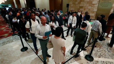 In this Tuesday, June 4, 2019 photo, job applicants line up at the Seminole Hard Rock Hotel & Casino Hollywood during a job fair in Hollywood, Fla. On Friday, June 7, the U.S. government issues the May jobs report.