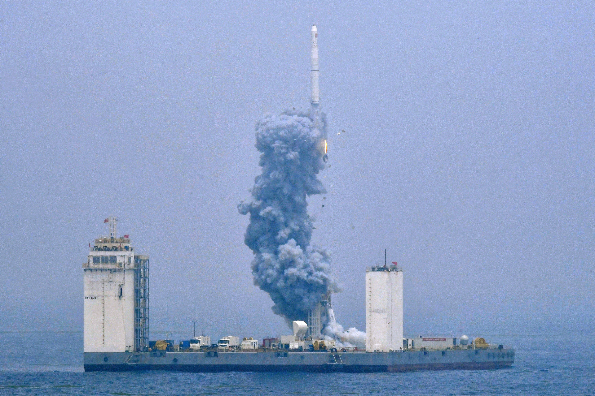 In this photo released by Xinhua News Agency, a Long March-11 solid propellant carrier rocket blasts off from a mobile launch platform in the Yellow Sea off east China's Shandong Province, Wednesday, June 5, 2019. China has for the first time launched a rocket from a mobile platform in the Yellow Sea, sending a five commercial satellites and two others containing experimental technology into space.
