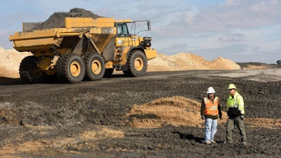 In this Nov. 14, 2017, file photo, crews with Duke Energy continue to remove coal ash from the old coal ponds at the Sutton Plant, in Wilmington, N.C. A toxic stew of coal ash has spilled repeatedly and apparently unnoticed from storage pits at a Wilmington power plant into an adjoining lake, according to a Duke University scientist who said Monday, June 3, 2019, that flooding last September from Hurricane Florence was only the latest example. The concentrations of lead, cobalt and other heavy metals detected in the sediment of the lake next to Duke Energy Corp.'s Sutton power plant equal or exceed the pollution from the country's worst coal-ash spill in Kingston, Tennessee, in 2008, geochemistry and water quality professor Avner Vengosh said in the research published last month.