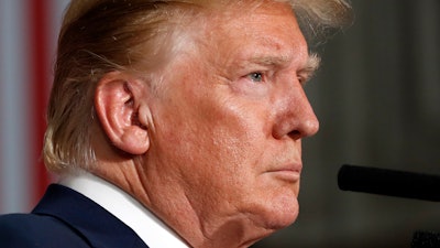President Donald Trump listens during a news conference with British Prime Minister Theresa May at the Foreign Office, Tuesday, June 4, 2019, in central London.