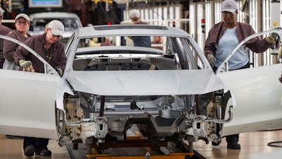 In this file photo, workers produce vehicles at Volkswagen's plant in Chattanooga.