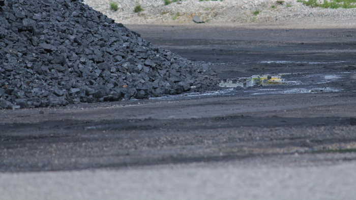 Coal Pile With Dirty Puddle 499534645 4272x2077 (1)