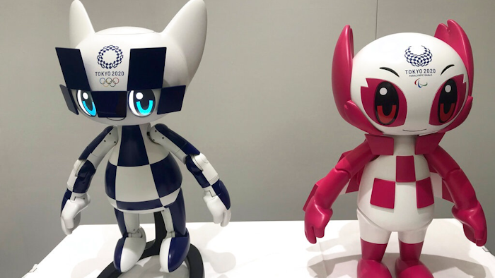 In this Thursday, July 18, 2019, photo, robots of mascots of Olympics 'Miraitowa,' left, and Paralympics 'Someity' are shown to the media at Toyota Motor Corp. headquarters in Tokyo. The mascot robots’ eyes change to the images of stars and hearts. The Japanese automaker Toyota, a major Olympic sponsor, is readying various robots for next year’s Tokyo Olympics.