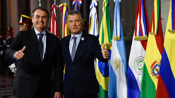 Argentina's President Mauricio Macri, right, gives a thumbs up to photographers with Brazil's President Jair Bolsonaro during a photo opportunity at the Mercosur Summit in Santa Fe, Argentina, Wednesday, July 17, 2019. The South American trading bloc that includes founding members Brazil, Argentina, Paraguay, and Uruguay, is one of the world's largest.