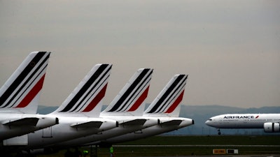 In this May 17, 2019 file photo, Air France planes are parked on the tarmac at Paris Charles de Gaulle airport, in Roissy, near Paris. The French government will implement an 'ecotax' on plane tickets for flights departing from France from next year, the government said Tuesday July 9, 2019. The tax is expected to raise over 180 million euros ($200 million) from 2020 to invest in eco-friendly transport infrastructure, including rail.