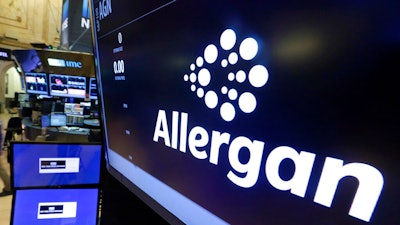 In this Monday, Nov. 23, 2015, file photo, the Allergan logo appears above a trading post on the floor of the New York Stock Exchange. On Wednesday, July 24, 2019, the medical device maker announced a worldwide recall of its Biocell breast implants which are linked to a rare form of cancer.