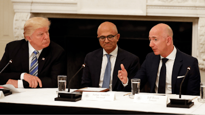In this file photo, Donald Trump, left, and Satya Nadella, Chief Executive Officer of Microsoft, center, listen as Jeff Bezos, Chief Executive Officer of Amazon, speaks during an American Technology Council roundtable in the State Dinning Room of the White House in Washington.