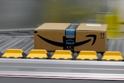 In this Feb. 9, 2018, file photo a box for an Amazon prime customer moves through the new Amazon Fulfillment Center in Sacramento, Calif. This year Prime Day is happening on two days: Monday, July 15, 2019, and Tuesday, July 16.
