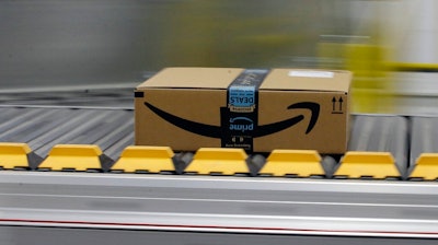 In this Feb. 9, 2018, file photo a box for an Amazon prime customer moves through the new Amazon Fulfillment Center in Sacramento, Calif. This year Prime Day is happening on two days: Monday, July 15, 2019, and Tuesday, July 16.