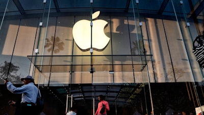 In this June 15, 2019, file photo customers leave an Apple store on the 3rd Street Promenade in Santa Monica, Calif. Apple Inc. reports financial results on Tuesday, July 30.