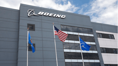 In this May 14, 2019, file photo flags fly outside the main building of The Boeing Company's Oklahoma City facility in Oklahoma City. Boeing Co. reports earning on Wednesday, July 24, 2019.