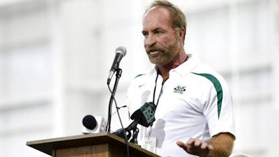 In this Sept. 6, 2014 photo, Chris Cline speaks as Marshall University dedicates the new indoor practice facility as the Chris Cline Athletic Complex in Huntington, W.Va. Police in the Bahamas say a helicopter flying from Big Grand Cay island to Fort Lauderdale has crashed, killing seven Americans on board. None of the bodies recovered from the downed helicopter have been identified, but police Supt. Shanta Knowles told The Associated Press on Friday, July 5, 2019, that the missing-aircraft report from Florida said billionaire Chris Cline was on board.