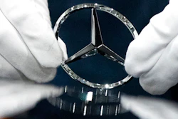 In this file photo dated Wednesday, April 3, 2019, a worker wipes a logo of a car at the Mercedes Benz automobile assembly plant outside Moscow, Russia. German automaker Daimler expects pretax profits this year to be significantly lower than 2018, after setting aside more money to tackle the fallout from its diesel emissions problems and an airbag recall.
