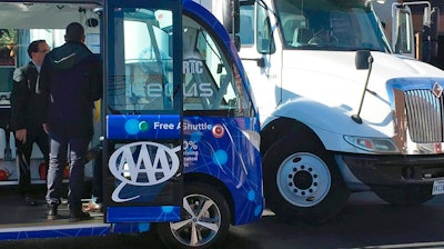 This Nov. 8, 2017, file photo by KVVU reporter Kathleen Jacob shows a driverless shuttle bus after it collided with a big rig in Las Vegas. Federal investigators say a collision between an experimental self-driving shuttle and a semi in downtown Las Vegas was probably the truck driver's fault. But the shuttle operator didn't have quick access to a controller that could have honked the horn or moved the shuttle, contributing to the accident.