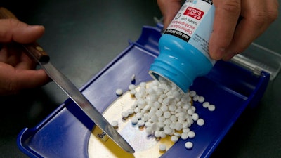 In this July 8, 2016, file photo, a prescription is filled at Pucci's Pharmacy in Sacramento, Calif. Four pharmaceutical companies are agreeing to pay California nearly $70 million to settle allegations that they delayed drugs to keep prices high. California Attorney General Xavier Becerra said Monday, July 29, 2019, that the bulk of the money will come from Teva Pharmaceutical Industries for paying to delay a generic narcolepsy drug from entering the market for nearly six years.