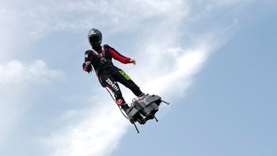 In this Wednesday July 24, 2019 file photo Franky Zapata, performs a training flight over the Saint Inglevert airport near Calais, Northern France. French inventor, Zapata, will try again to traverse the English Channel on a flying board after his first attempt last week failed halfway.