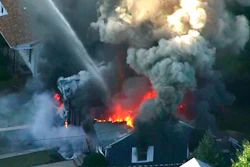 In this Sept. 13, 2018 file image from video provided by WCVB in Boston, flames consume the roof of a home following an explosion in Lawrence, Mass. Columbia Gas of Massachusetts and its parent, NiSource Inc., announced Monday, July 29, 2019, a settlement had been reached in class action lawsuits resulting from the disaster across several towns north of Boston.