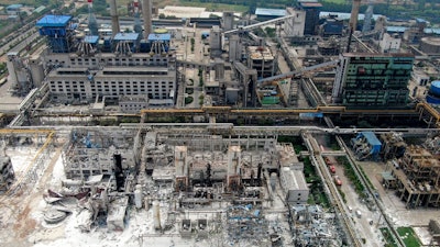 An aerial view shows the aftermath of the blast at a gas plant in Yima city in central China's Henan province Saturday, July 20, 2019. The Friday evening explosion shattered windows 3 kilometers (1.9 miles) away, and knocked off doors inside buildings, killing some and injuring others.