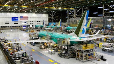 This Dec. 7, 2015, file photo shows the second Boeing 737 MAX airplane being built on the assembly line in Renton, Wash. American Airlines says it will keep the Boeing 737 Max plane off its schedule until Nov. 3, 2019, which is two months longer than it had planned. In a statement Sunday, July 14, American says the action will result in the cancellation of about 115 flights per day.