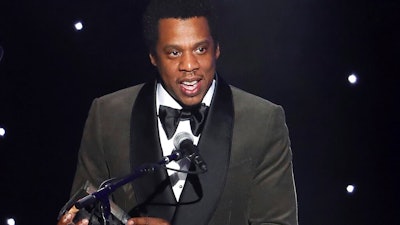 In this Jan. 27, 2018, file photo, honoree Jay-Z speaks onstage at the 2018 Pre-Grammy Gala And Salute To Industry Icons at the Sheraton New York Times Square Hotel in New York. Jay-Z’s business entities have sued a New York City licensing firm, claiming it cheated the companies as part of a “colossal accounting scandal.” The lawsuit, filed on Thursday, July 4, 2019, in Manhattan, accuses Iconix Brand Group Inc. of lying about its finances when it made deals with the rapper’s Roc Nation apparel company.