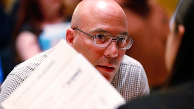 In this June 4, 2019, file photo, job applicant Juan Ramon Velazquez answers questions as he is called up at the Seminole Hard Rock Hotel & Casino Hollywood during a job fair in Hollywood, Fla. On Wednesday, July 31, payroll processor ADP reports on how many jobs its survey estimates U.S. companies added in July.