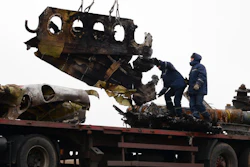 In this file photo dated Sunday, Nov. 16, 2014, recovery workers in rebel-controlled eastern Ukraine load debris from the crash site of Malaysia Airlines Flight 17, in Hrabove, Ukraine, with recovery operations carried out under the supervision of Dutch investigators and officials from the Organization for Security and Cooperation in Europe. Five years after a missile blew Malaysia Airlines Flight 17 out of the sky above eastern Ukraine, relatives and friends of those killed will gather Wednesday July 17, 2019, at a Dutch memorial to mark the anniversary.