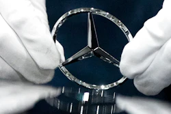 In this file photo dated Wednesday, April 3, 2019, a worker wipes a logo of a car at the Mercedes Benz automobile assembly plant outside Moscow, Russia. German automaker Daimler expects pretax profits this year to be significantly lower than 2018, after setting aside more money to tackle the fallout from its diesel emissions problems and an airbag recall.