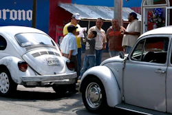 Taxi drivers gather around their Volkswagen Beetles in a neighborhood of Mexico City known colloquially as 'Vocholandia,' for its love of the classic Beetle, called 'vocho', Tuesday, July 9, 2019. Green-and-white painted Beetles used as taxis used to be the norm in Mexico City, but authorities expired the cab licenses for the last of the 'vochos' in in 2012.