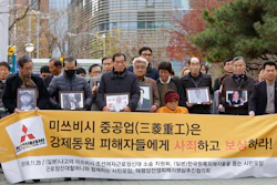 In this Nov. 29, 2018, file photo, victims of Japan's forced labor and their family members arrive at the Supreme Court in Seoul, South Korea. Colonial-era Korean laborers on Tuesday, July 16, 2019, are seeking a court's approval for the sales of local assets of their former Japanese employer after it refused to comply with a court order to compensate them for forced labor decades ago. The sign reads 'Mitsubishi Heavy Industries should compensate and apologize to victims of forced labor.'