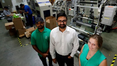 In this Friday, July 5, 2019, file photo Achyut Patel, Director of Operations, Rudy Patel, Director of Business Development an Katrina Hart, business development coordinator pose for a picture at beyond Green, a maker of biodegradable bags in Lake Forest, Calif.