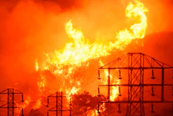 In this Dec. 16, 2017, file photo provided by the Santa Barbara County Fire Department, flames burn near power lines in Sycamore Canyon near West Mountain Drive in Montecito, Calif. A Wednesday, July 10, 2019, report in the Wall Street Journal says Pacific Gas & Electric, which is blamed for some of California's deadliest recent fires, knew for years that dozens of its aging power lines posed a wildfire threat but avoided replacing or repairing them. PG&E says it disagrees with the Journal's conclusions but says it’s 'taking significant actions to inspect, identify, and fix' safety issues.