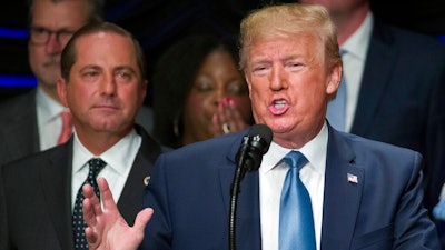 President Donald Trump speaks about kidney health at the Ronald Reagan Building and International Trade Center, accompanied by Health and Human Services Secretary Alex Azar, left, Wednesday, July 10, 2019, in Washington.