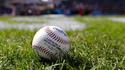 A baseball is pictured as the American League warms-up for the MLB baseball All-Star Game, Tuesday, July 9, 2019, in Cleveland. Faced with a record onslaught of home runs and pitchers convinced baseballs are juiced, Commissioner Rob Manfred says the sport has been unable to find any changes in the manufacturing process.